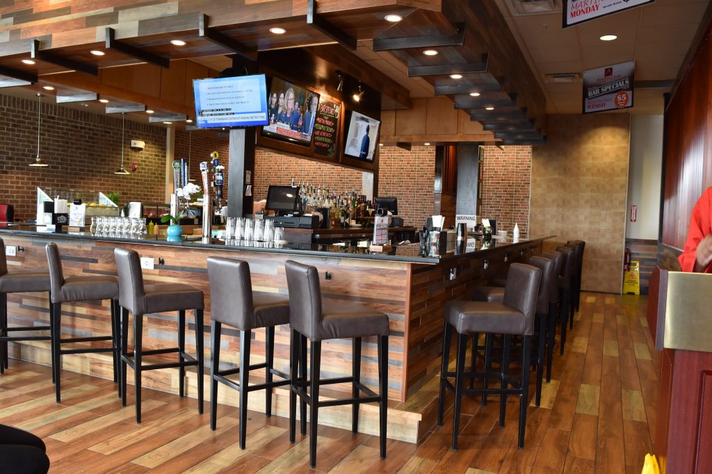 A picture of stools and a bar from the Steak Sushi location.